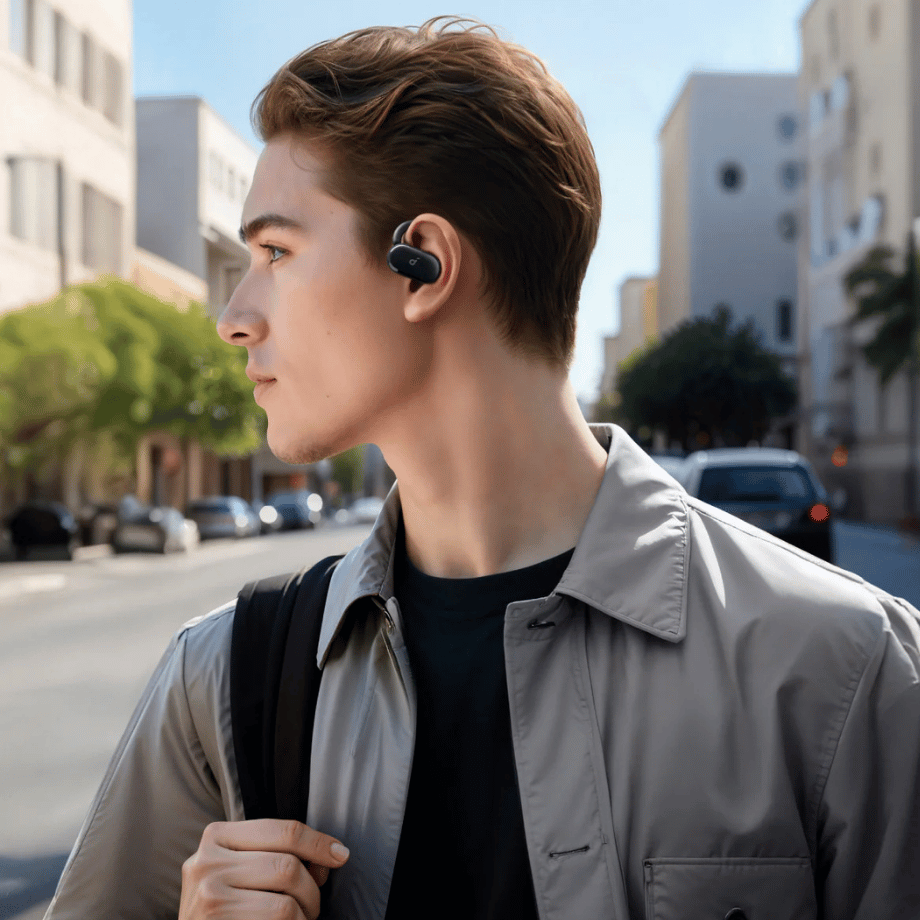 Anker Soundcore V20i Open Ear Earbuds in Urban Setting Person wearing Anker Soundcore V20i Open Ear Earbuds while walking outdoors.